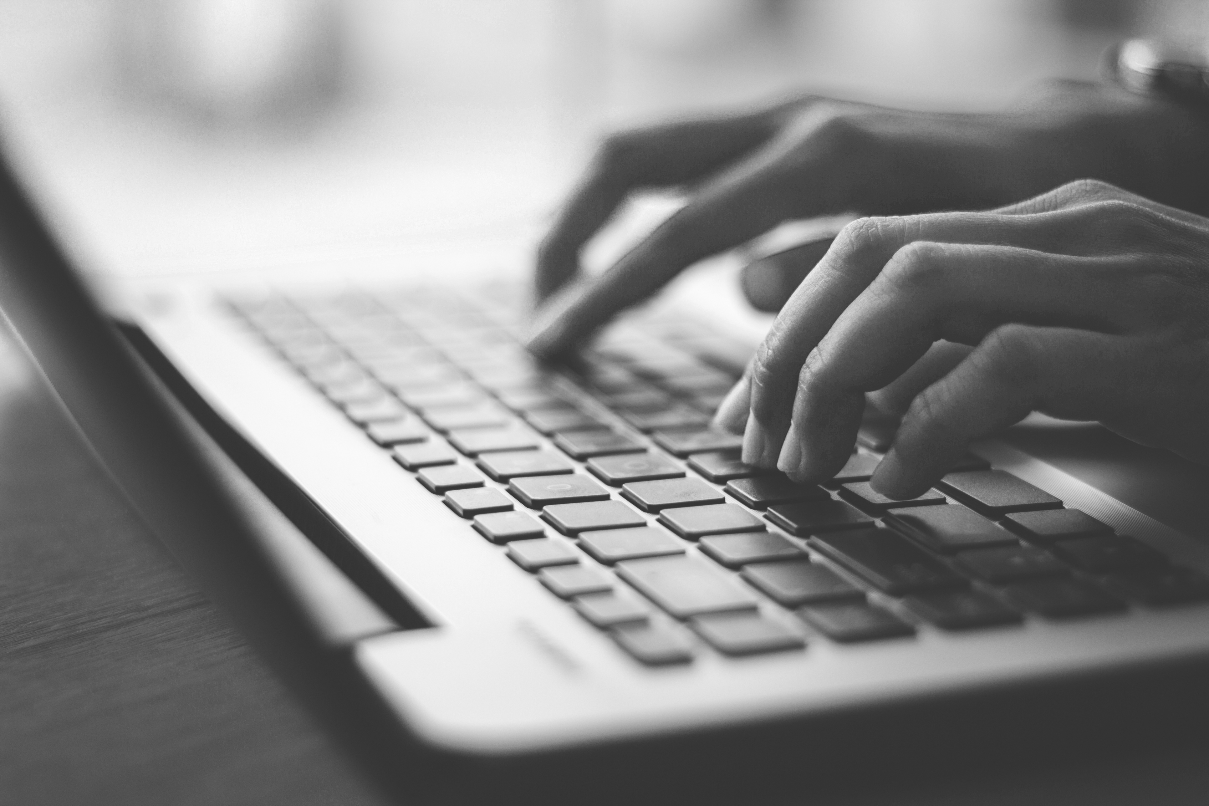 Hands typing on a keyboard